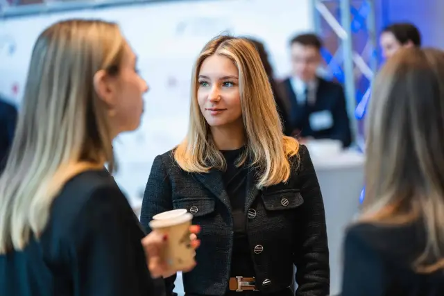 Participants talking over coffee during a break