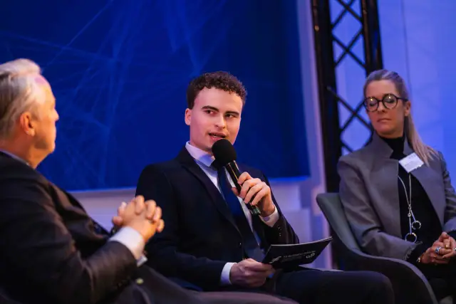 A student moderator leading a panel on security