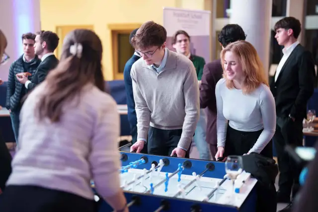Participants playing table football during a break