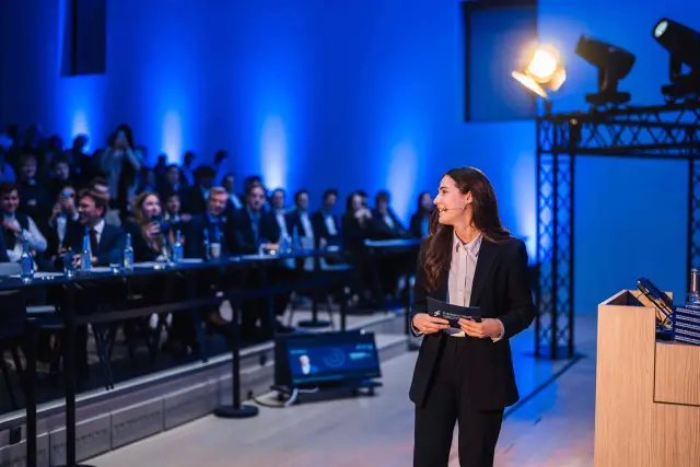 The moderator opening a session in front of a seated audience